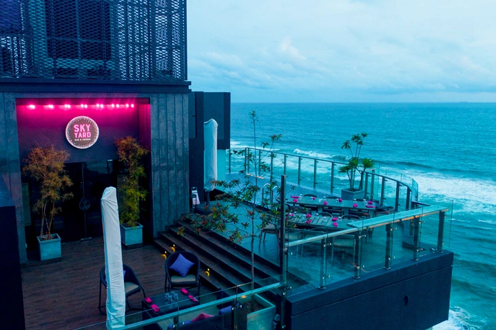 The Sky Yard is a rooftop oasis that combines sleek design with breathtaking ocean views, providing a perfect retreat for relaxation or a lively evening with friends.